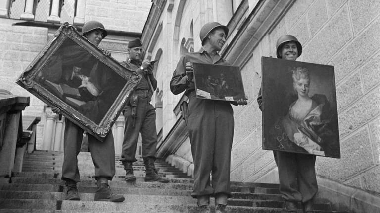 American soldiers hold some of the art that had been looted...
