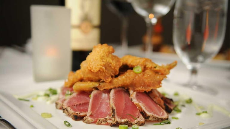 Asian rare-seared yellowfin tuna with tempura vegetables is served at...