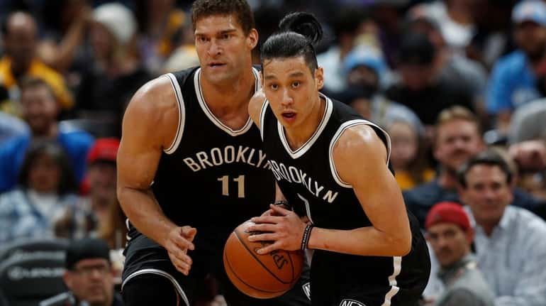 Brooklyn Nets guard Jeremy Lin, front picks up the ball...