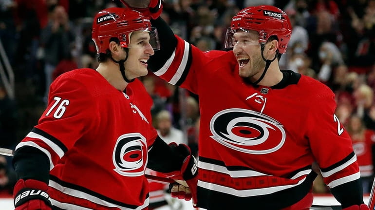 The Hurricanes' Brady Skjei is congratulated on his goal by teammate...