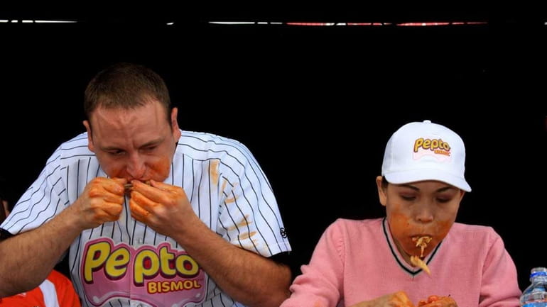 Competitive eater Joey Chestnut battles three-time Wingfest champion Sonya Thomas...