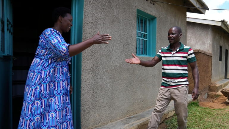 Genocide survivor Jeanette Nyirabashyitsi, 45, left a Tutsi, greets Frederick...