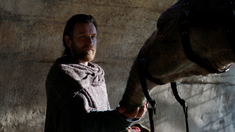 Obi-Wan Kenobi (Ewan McGregor) with an eopie in a scene...