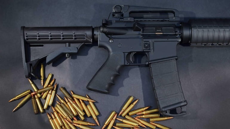 A Rock River Arms AR-15 rifle is seen with ammunition...