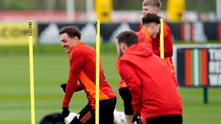 Wales' Connor Roberts, left, and teammates attend a training session...