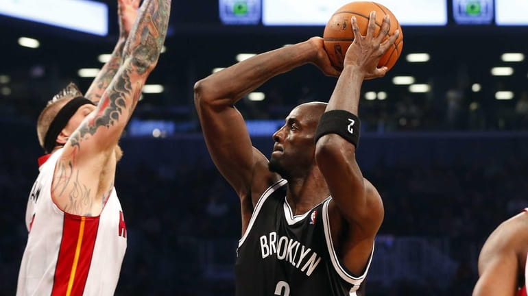 Kevin Garnett of the Nets takes a shot in the...