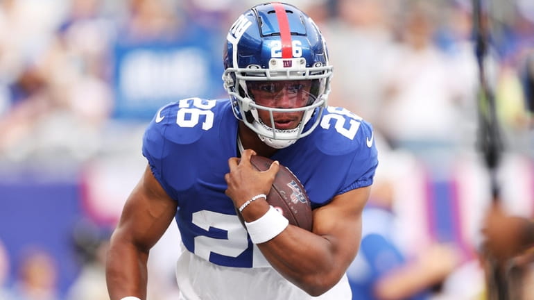Saquon Barkley of the Giants carries the ball during warmups of a...