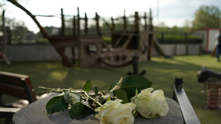 Roses lay at the playground after a knife attack Thursday,...