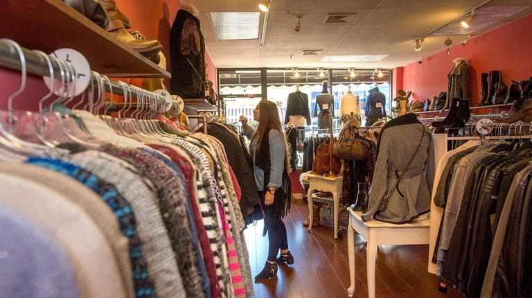 A shopper browsing the clothes at Lucky Finds Boutique in...