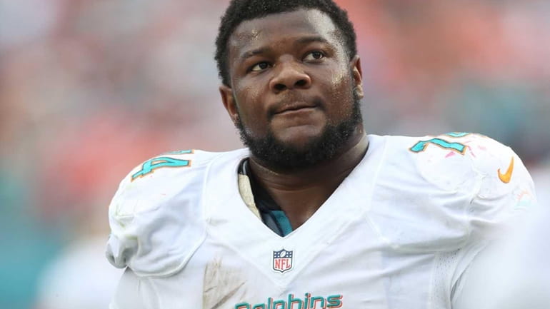 Miami Dolphins offensive guard John Jerry looks up from the...
