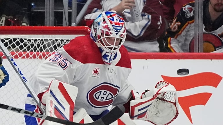 Montreal Canadiens goaltender Sam Montembeault deflects puck in the second...