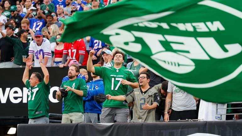 New York Jets fans cheer during the second half of...