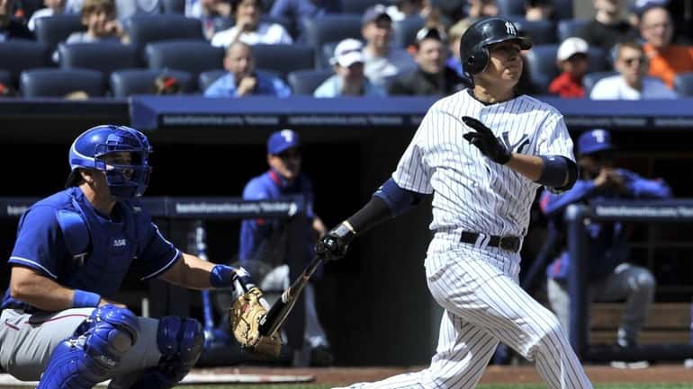 Yankees' Ramiro Pena hits a two-run single in the third...