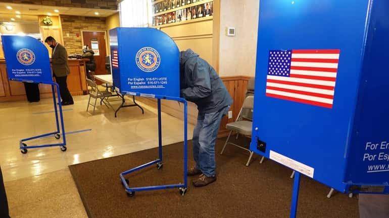 Voters cast their ballots at the American Legion Post 1273 in...