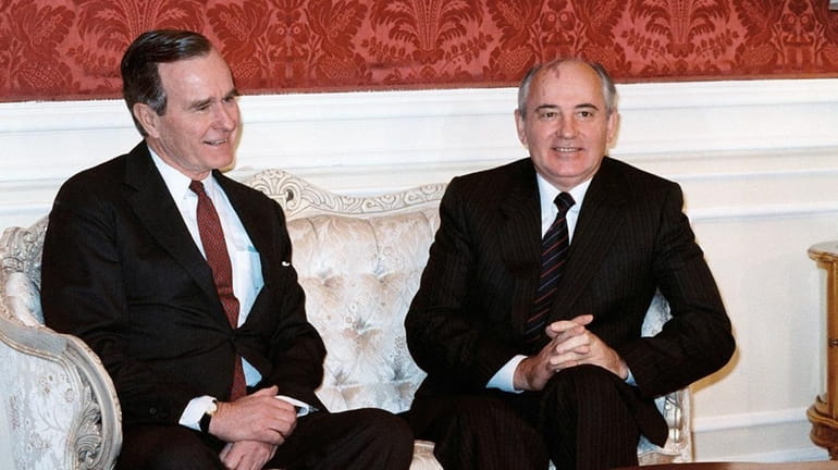 Soviet leader Mikhail Gorbachev (R) meets with US Vice-President George...