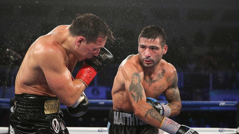 Lucas Matthysse, right, throws a right cross to the head...