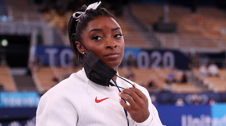 Simone Biles of the United States looks on during the...