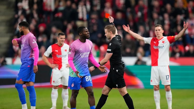 Referee Jindrich Trpisovsky shows the red card to the Slavia's...