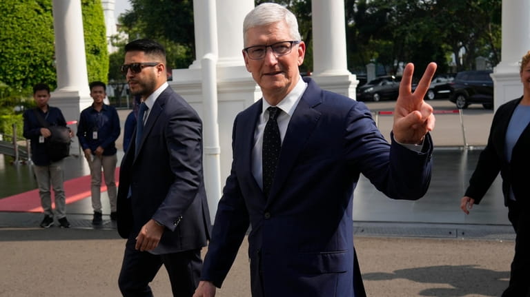 Apple CEO Tim Cook arrives for a meeting with Indonesian...