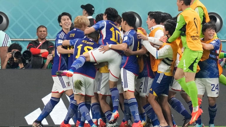 Japan players celebrate after Japan's Ritsu Doan scored his side's...