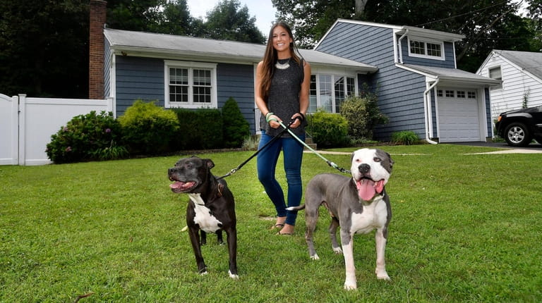 Kacie Martinez and dogs Sonya and Kano in front of...