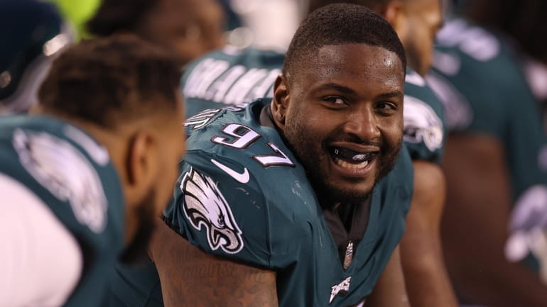 Javon Hargrave of the Eagles smiles from the sidelines against the 49ers...