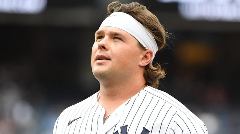 Yankees designated hitter Luke Voit walks to the dugout after...