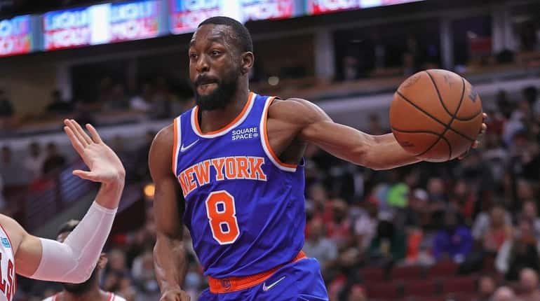 Kemba Walker #8 of the Knicks leaps to pass against...