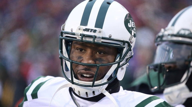Jets wide receiver Brandon Marshall looks on from the sideline...