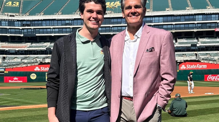 Oakland Athletics broadcaster Chris Caray, left, and his father, Chip,...