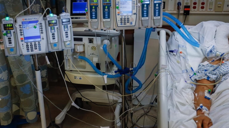 A COVID-19 patient is connected to life-sustaining devices at Mount Sinai...