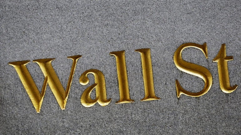 A sign for Wall Street carved into the side of...
