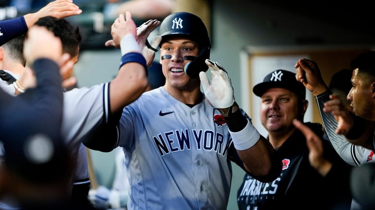 Yankees' Aaron Judge is greeted in the dugout after hitting...