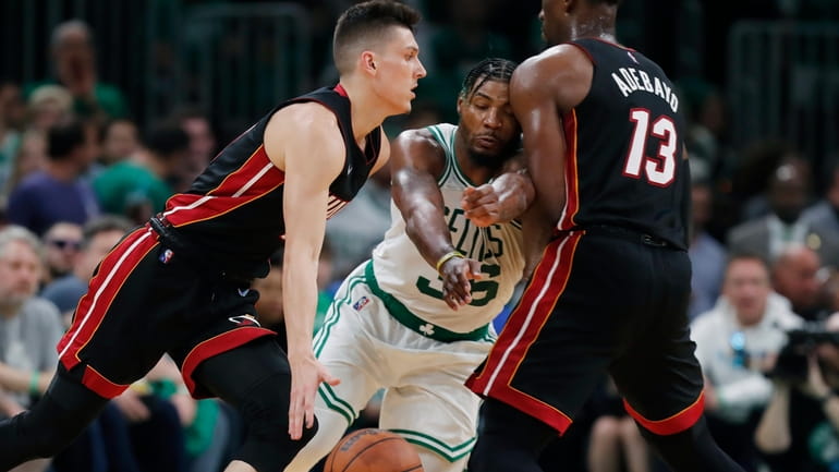 Miami Heat's Bam Adebayo (13) screens Boston Celtics' Marcus Smart...