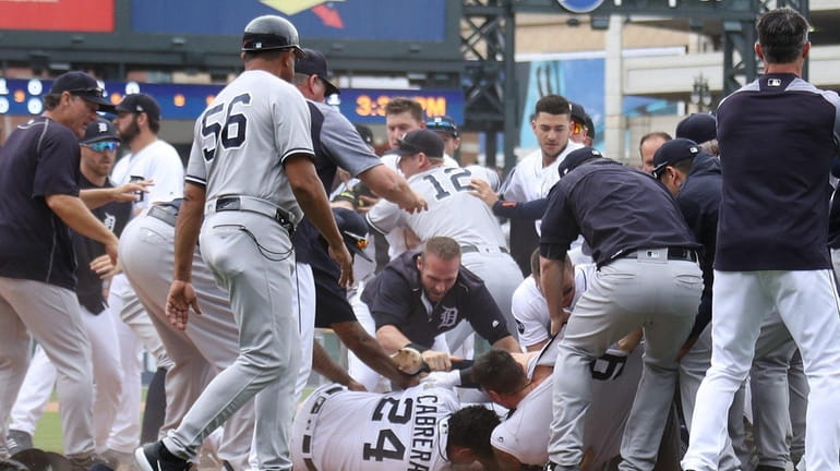 Tigers' Miguel Cabrera lays on the ground during a benches-clearing...