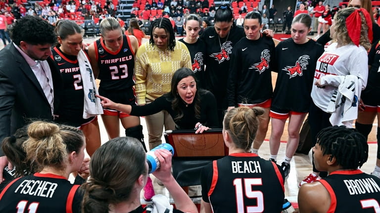 Fairfield coach Carly Thibault, center, speaks with her team during...