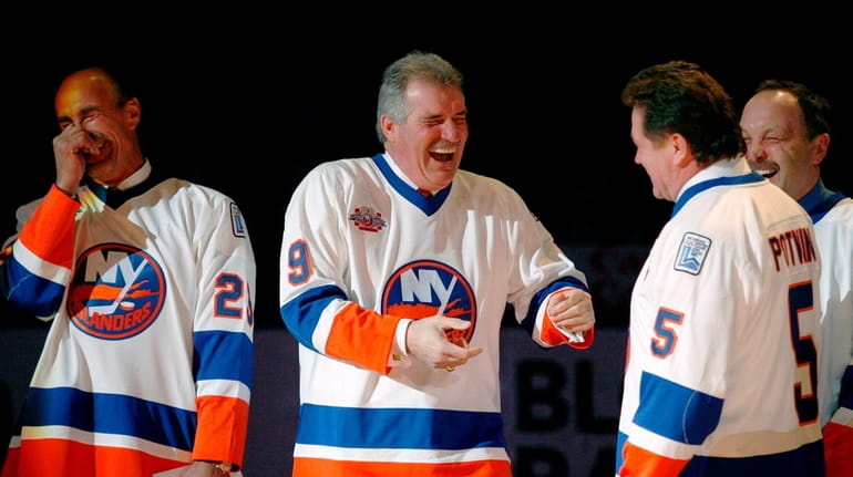 Clark Gillies, second from left, greets Denis Potvin, second from...
