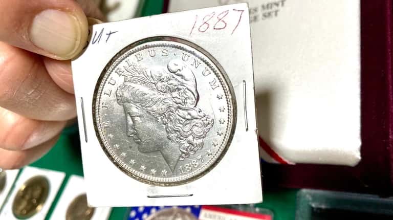 Anthony Langan holds an 1887 Morgan silver dollar.