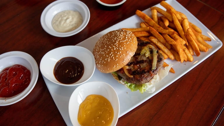 The original Okuz Burger with seasoned fries and sauces at...
