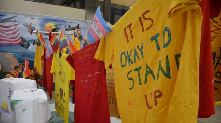 T-shirts hang with messages against domestic violence at the "Commemoration...