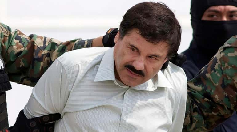 Joaquín "El Chapo" Guzmán Loera is escorted to a helicopter in...