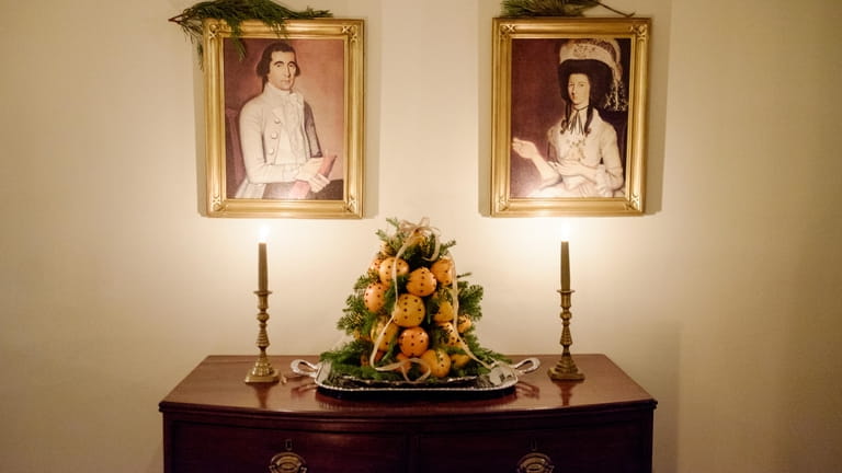 Oranges speckled with cloves and evergreen create an eye-catching centerpiece...