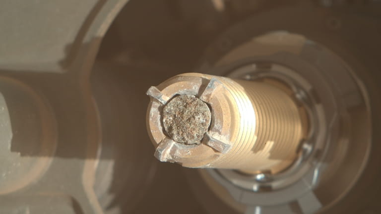 This photo provided by NASA shows a coring bit used...