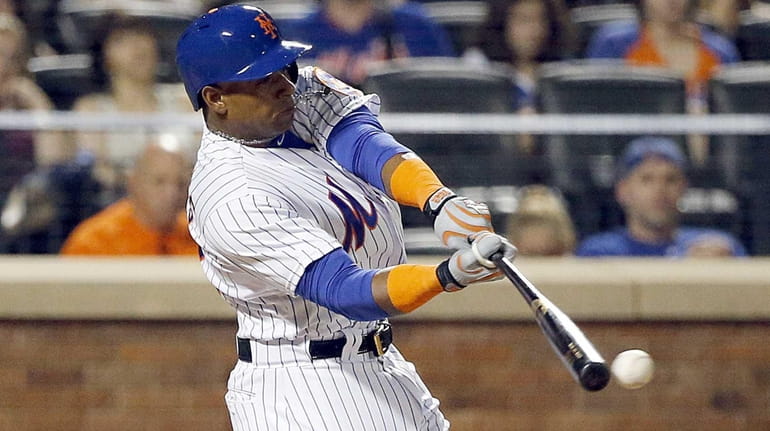 New York Mets leftfielder Yoenis Cespedes connects for a foul...