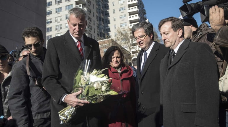 Mayor Bill de Blasio lays flowers with French Ambassador Gerard...