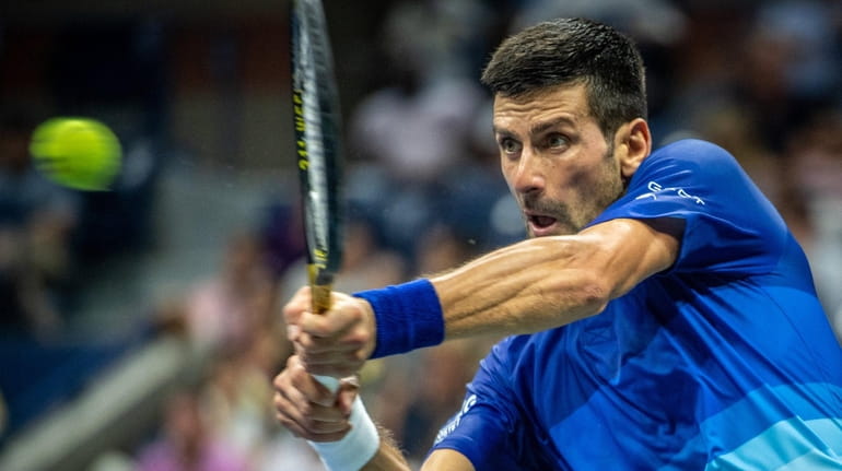 Novak Djokovic hits a backhand against Matteo Berrettini in the first...