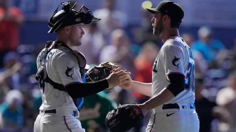 Miami Marlins catcher Nick Fortes, left, and relief pitcher Dylan...