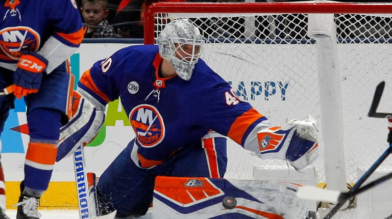 Robin Lehner #40 of the Islanders makes a save against the...