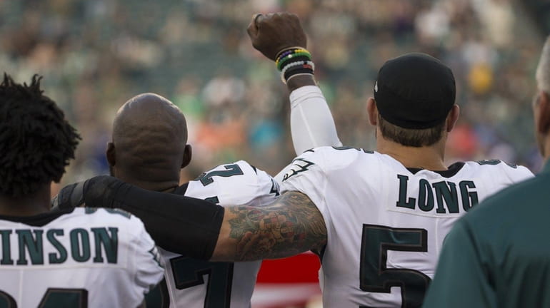 Malcolm Jenkins and Chris Long of the Eagles react during...