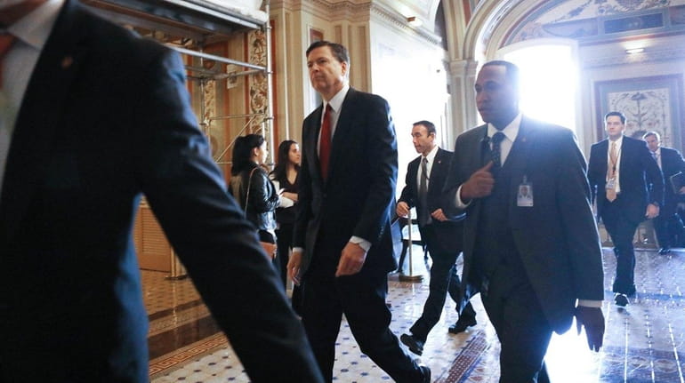 FBI director James Comey leaves the Capitol after a meeting...